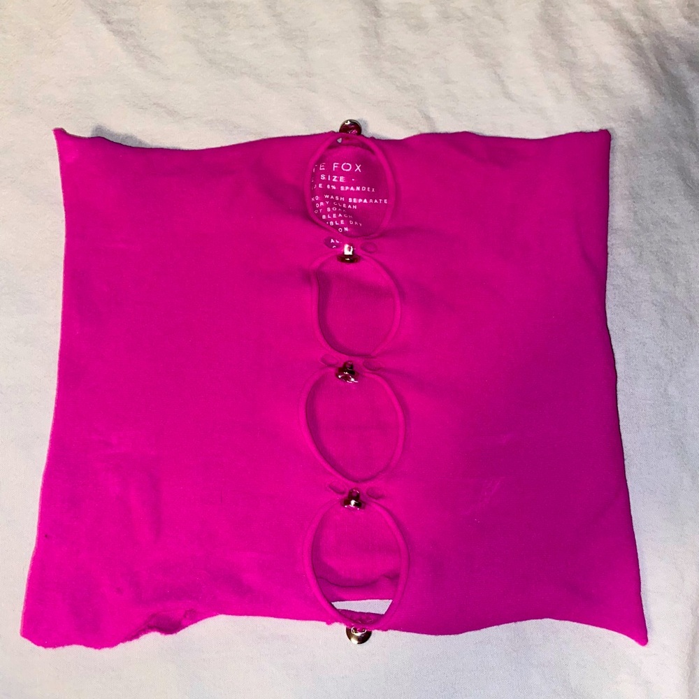 I am selling a White Fox tube top it is pink with gems and an open front
